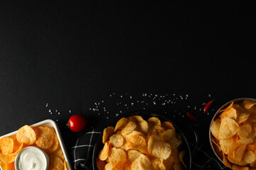 Wall Mural - Potato chips in bowls with sauce on a dark background