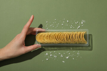 Wall Mural - Potato chips in a plastic tray on a green background