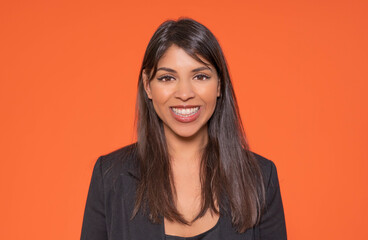 Smiling Woman In Black Blazer Against Orange Background