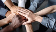 © ranahpixel - people fold their hands in unity while working together.