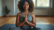 © Anna - Woman meditating on yoga mat in a peaceful home setting for mindfulness and relaxation. Yoga practice, mental wellness, home workout, stress relief, healthy lifestyle, self-care, meditation.