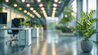 © visoot - Modern open space business office interior without people, featuring tables, chairs, and computers, blurred bokeh light background, sleek and contemporary design, green office concept with plants.