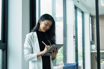 Wall Mural - Businesswoman working using tablet.