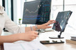 © MIND AND I - Young woman examines stock graphs at tablet