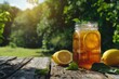 © Syahrul Zidane A - A mason jar filled with homemade iced tea and a slice of lemon on a wooden table with nature background