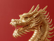 © Hugo - a gold dragon statue with a red background