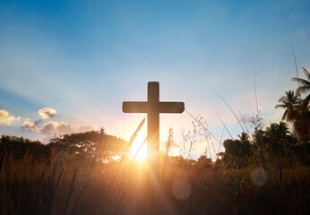 Wall Mural - Silhouette of catholic cross at sunset background.
