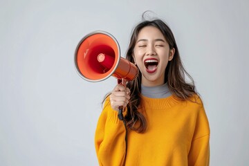 Joyful Asian lady exclaiming and revealing great news or advancement against white backdrop.