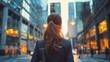 © Usman - Rear view of business woman in business city center