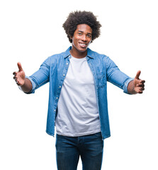 Wall Mural - Afro american man over isolated background looking at the camera smiling with open arms for hug. Cheerful expression embracing happiness.