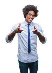 Canvas Print - Afro american business man wearing glasses over isolated background pointing fingers to camera with happy and funny face. Good energy and vibes.