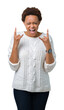 © Krakenimages.com - Beautiful young african american woman wearing sweater over isolated background shouting with crazy expression doing rock symbol with hands up. Music star. Heavy concept.