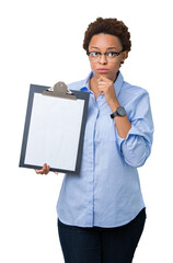 Sticker - Young african american businesss woman holding clipboard over isolated background serious face thinking about question, very confused idea