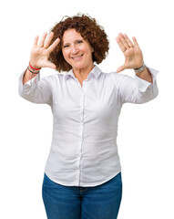 Wall Mural - Beautiful middle ager senior businees woman over isolated background Smiling doing frame using hands palms and fingers, camera perspective