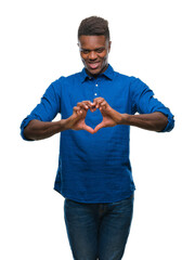 Wall Mural - Young african american man over isolated background smiling in love showing heart symbol and shape with hands. Romantic concept.