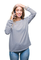 Poster - Beautiful young blonde woman talking on smarpthone over isolated background stressed with hand on head, shocked with shame and surprise face, angry and frustrated. Fear and upset for mistake.