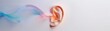 © Bantita - Closeup of an ear surrounded by colorful sound waves, representing the active reception of words, engaged listening