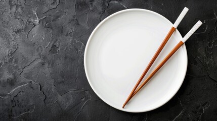 Canvas Print - Chopsticks and white plate on dark stone