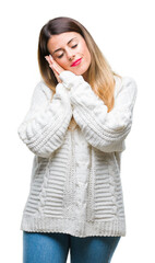 Sticker - Young beautiful woman casual white sweater over isolated background sleeping tired dreaming and posing with hands together while smiling with closed eyes.