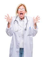 Sticker - Middle age blonde doctor woman over isolated background celebrating crazy and amazed for success with arms raised and open eyes screaming excited. Winner concept