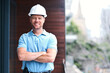© peopleimages.com - Architecture, arms crossed and portrait of happy man with safety at remodeling site, home improvement and deal plan. Engineering, contractor and confidence to hard hat, industry and face with smile