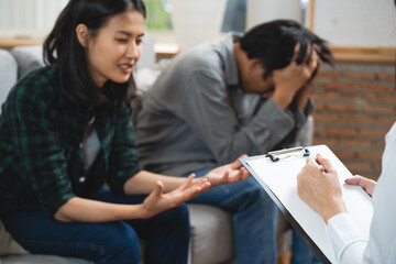 Wall Mural - psychologist talking with married couple about depression of husband.