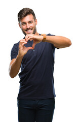 Sticker - Young handsome man over isolated background smiling in love showing heart symbol and shape with hands. Romantic concept.