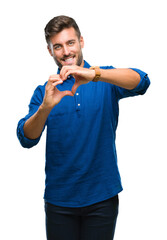 Poster - Young handsome man over isolated background smiling in love showing heart symbol and shape with hands. Romantic concept.