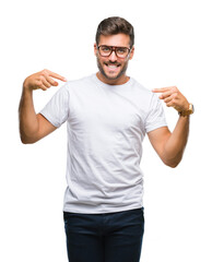 Wall Mural - Young handsome man wearing glasses over isolated background looking confident with smile on face, pointing oneself with fingers proud and happy.