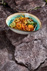 Wall Mural - Delicious Shrimp Udon with Cilantro and Soy Sprouts on a Stone Background