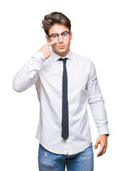 Wall Mural - Young business man wearing glasses over isolated background Pointing with hand finger to face and nose, smiling cheerful