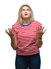 Poster - Young caucasian woman over isolated background crazy and mad shouting and yelling with aggressive expression and arms raised. Frustration concept.