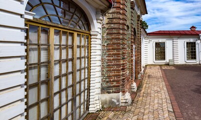 Close-up of a historic building's exterior showcasing a blend of brick and wood elements with intricate window designs, highlighting the architectural details and weathered textures