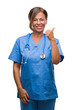 © Krakenimages.com - Middle age senior nurse doctor woman over isolated background doing happy thumbs up gesture with hand. Approving expression looking at the camera with showing success.
