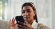 © WesSide/peopleimages.com - Cellphone, confused and indian woman online, reading and bad news article on social media. Doubt, home and living room for mobile app and internet, person frown and scroll with email on lounge sofa