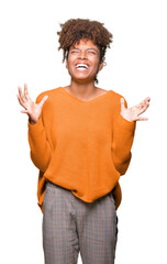 Wall Mural - Beautiful young african american woman over isolated background crazy and mad shouting and yelling with aggressive expression and arms raised. Frustration concept.