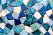© Natalia - Professional photograph of intricate mosaic tiles featuring geometric designs in vibrant shades of blue, gold, and white
