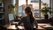 © Adam - A woman working at her home office desk with a computer, surrounded by plants and natural light from the window.