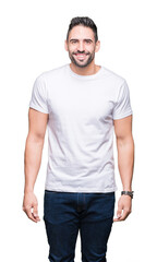 Canvas Print - Young man wearing casual white t-shirt over isolated background with a happy and cool smile on face. Lucky person.