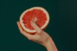 © ArtSpree - Female hand close-up crushes grapefruit on a black background. Studio isolated background.. Beautiful simple AI generated image in 4K, unique.