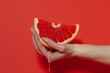 © ArtSpree - Female hand close-up crushes grapefruit on a black background. Studio isolated background.. Beautiful simple AI generated image in 4K, unique.