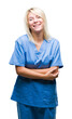 © Krakenimages.com - Young beautiful blonde nurse doctor woman over isolated background happy face smiling with crossed arms looking at the camera. Positive person.