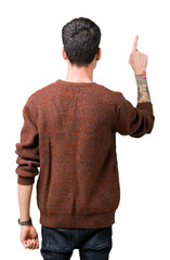 Wall Mural - Young handsome man wearing winter sweater over isolated background Posing backwards pointing behind with finger hand