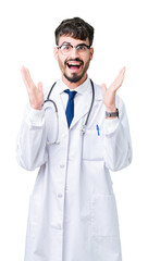 Wall Mural - Young doctor man wearing hospital coat over isolated background celebrating crazy and amazed for success with arms raised and open eyes screaming excited. Winner concept