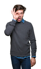 Poster - Young handsome elegant man over isolated background doing ok gesture shocked with surprised face, eye looking through fingers. Unbelieving expression.