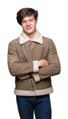 Sticker - Young handsome man wearing winter coat over isolated background happy face smiling with crossed arms looking at the camera. Positive person.