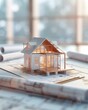 © dip - A small house model on on construction blueprints with architectural drawing lines, symbolizing home construction and real estate design