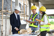 © Prathankarnpap - Male project manager and engineers discussing project details at building site