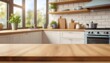 © Artanto - Kitchen wood table top for product display with blurred modern interior.