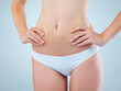 © peopleimages.com - Woman, underwear and health in studio, stomach and diet for result and weight loss on white background. Wellness, abdomen or hands on body for female person, slim and gut and nutrition support